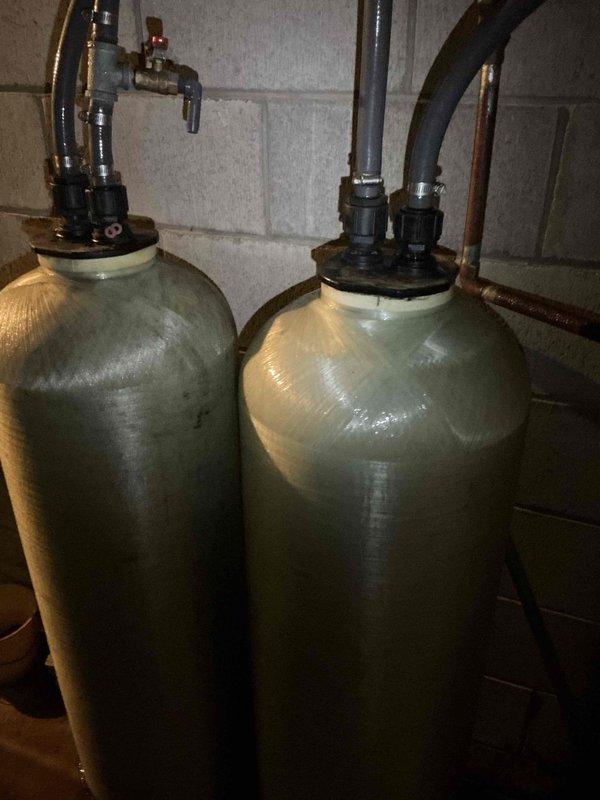 Responded to no cooling call on aging HVAC system where evaporator coil was completely iced over and compressor was running. Found furnace blower not functioning, which prevented proper airflow through the system and caused the freeze-up. Documented condensation on refrigerant lines and iced coil condition with photos. Advised system shutdown to allow ice to melt completely before further diagnosis, as frozen coil prevents accurate assessment of underlying issues with the 40-50 year old furnace blower motor and overall system operation.