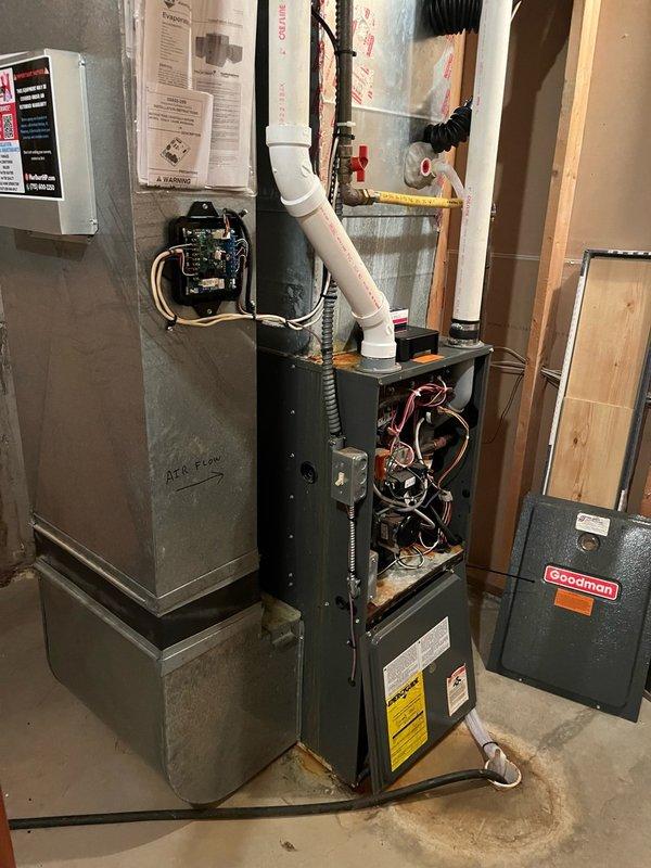 Responded to no-cool condition following new AC installation where blower motor would not engage. Verified thermostat was calling for fan operation, but furnace was unresponsive. Replaced capacitor initially with no improvement. Performed diagnostic testing and confirmed control board was receiving thermostat signal but failing to send power to blower motor during fan and cooling calls. Determined control board failure as root cause. Observed frozen evaporator coil with water leakage into cabinet, indicating restricted airflow from non-operational blower. Documented findings with photos of furnace interior, wiring harnesses, and failed control board assembly. Advised customer that control board replacement is required and system will need refrigerant charge once blower operation is restored.