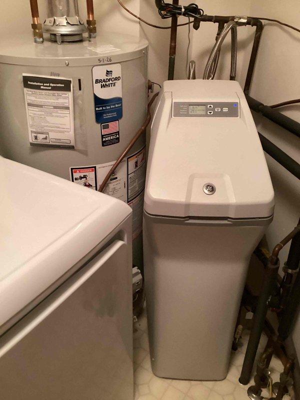 Responded to service call for water softener malfunction where salt level was not decreasing after regeneration cycles. Upon inspection, identified a salt bridge formation in the brine tank preventing proper salt dissolution. Broke up the salt bridge using manual methods to restore proper salt flow and system operation. Verified water softener unit returned to normal functioning with proper salt consumption during regeneration cycle.