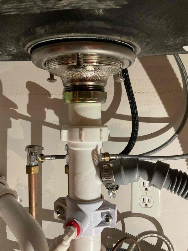 Completed no-charge callback to install customer-supplied basket strainer and replace dishwasher tailpiece at kitchen sink. Removed existing drain assembly and installed new strainer with proper sealing, ensuring secure mounting through sink basin. Replaced inadequate dishwasher tailpiece with correct-length component and verified all tubular drain fittings met proper extension requirements for leak-free connections. Tested complete drainage system under running water to confirm no blockages or slow-draining issues present. All connections secured and system returned to full operation.