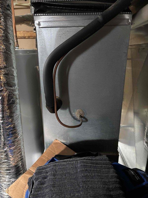 Completed comprehensive AC maintenance on single-zone residential cooling system utilizing R-410A refrigerant with ambient temperature at 61 degrees. Performed full system inspection including air filter, thermostat operation, temperature split analysis, outdoor condenser unit, evaporator and condenser coils, blower motor, capacitors, compressor function, refrigerant charge levels, and condensate drain line. Installed customer-provided 20x25x4 air filter. Identified failed dual-run capacitor (35+10 MFD) and defective service cap requiring replacement. Upon approval, replaced capacitor and service cap, tested system operation, and verified all components functioning within normal parameters. System operating efficiently at completion of service.