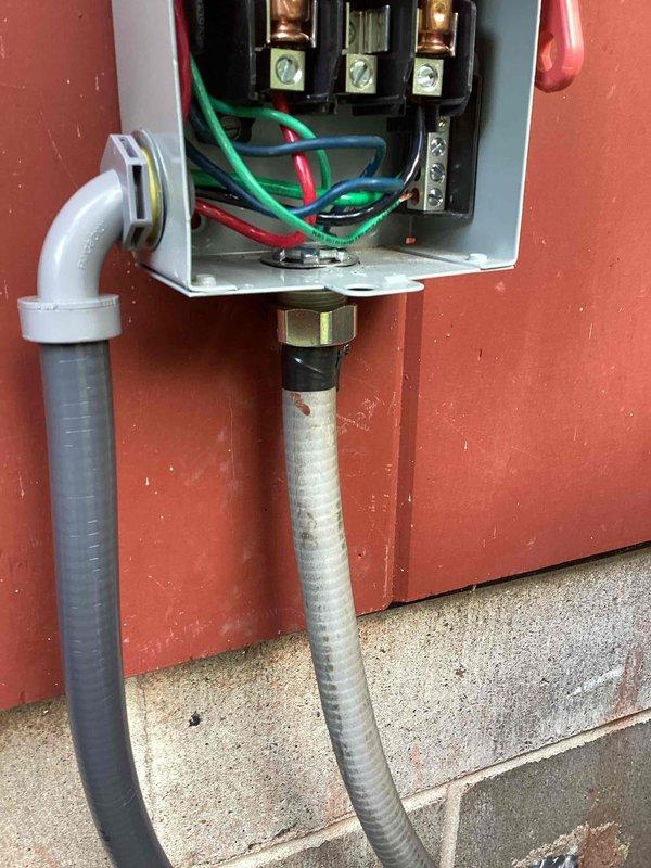 Responded to callback for AC unit lacking proper grounding on high voltage circuit. Identified missing ground wire from interior junction box to exterior condensing unit and absence of proper connector on metallic sealtight conduit. Ran new high voltage wiring from basement junction box above lineset to outdoor unit, installed ground wire through flexible conduit, and added appropriate metallic connector to sealtight flex. Verified all electrical connections at disconnect box and secured proper grounding throughout circuit per code requirements.