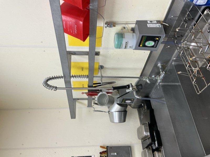 Responded to a clogged drain at a commercial deli location. Successfully cleared a blockage located approximately 10 feet into the pan wash sink drain line using appropriate drain cleaning equipment. During the service visit, documented additional plumbing issues requiring future attention, including a faucet and compression fitting that need replacement, a leaking three-compartment sink, and a hand wash sink with slow drainage caused by improper back-pitched piping within the wall. Photographed all identified issues for parts ordering and future repair scheduling.