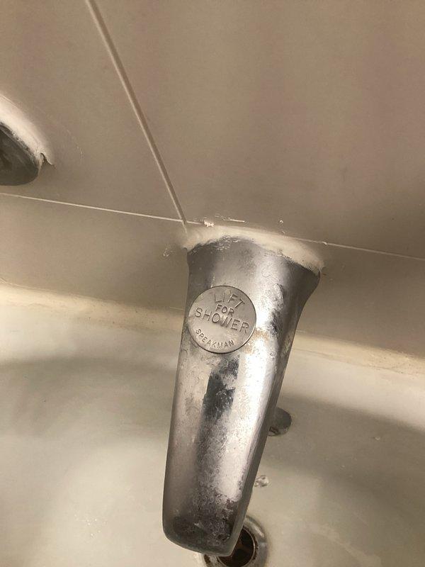 Responded to service call for malfunctioning shower fixture in unit 201. Upon inspection, identified worn cartridge in older model tub/shower valve assembly requiring replacement. Due to age of fixture and specialized Belgian-manufactured components, determined that cartridge would need to be special ordered. Documented existing three-valve configuration with chrome handles and spout showing mineral buildup and wear. Submitted parts order request and provided repair estimate for cartridge replacement to proceed with service completion upon parts arrival.