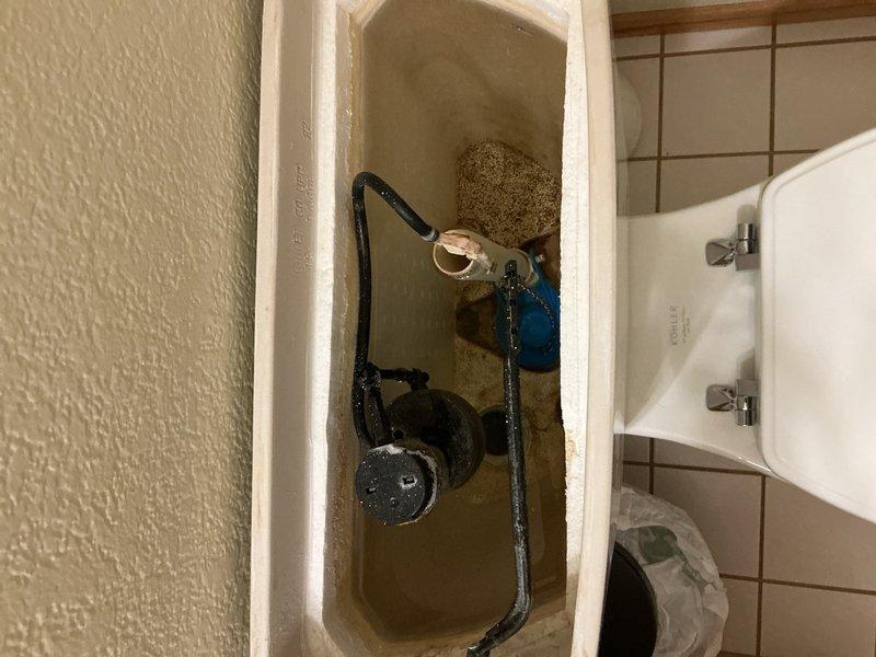 Responded to call regarding suspected water leak in residence following recent septic system replacement. Upon investigation, identified malfunctioning automatic sediment filter running continuously and toilet fill valve failing to shut off properly. Inspected toilet tank components and confirmed fill valve assembly was not seating correctly, causing constant water flow and contributing to excessive water usage. Documented existing conditions with photographs showing discolored water in tank and worn internal flush mechanism components including flapper valve, fill valve assembly, and chain connections. Provided estimates for replacement of defective fixtures to resolve leak issue and restore proper operation.