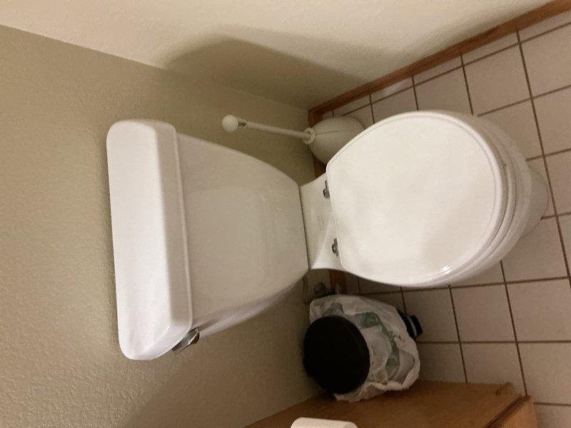 Responded to call regarding suspected water leak in residence following recent septic system replacement. Upon investigation, identified malfunctioning automatic sediment filter running continuously and toilet fill valve failing to shut off properly. Inspected toilet tank components and confirmed fill valve assembly was not seating correctly, causing constant water flow and contributing to excessive water usage. Documented existing conditions with photographs showing discolored water in tank and worn internal flush mechanism components including flapper valve, fill valve assembly, and chain connections. Provided estimates for replacement of defective fixtures to resolve leak issue and restore proper operation.