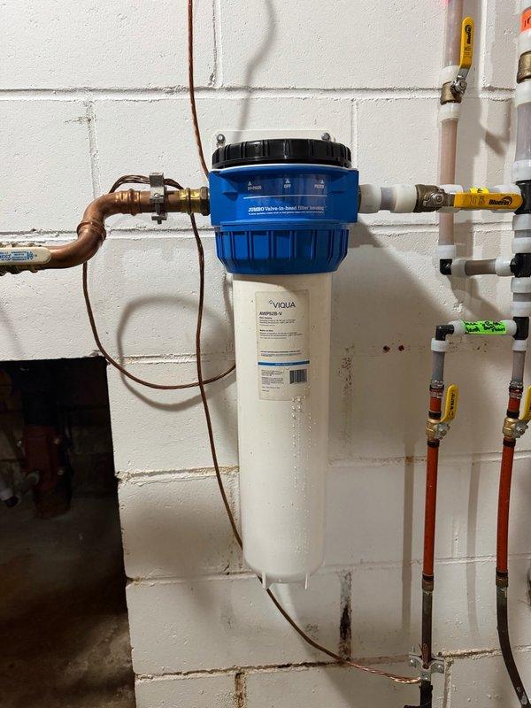 Replaced iron filter cartridge on whole-house VIQUA water filtration system. Removed existing cartridge from filter housing, installed new iron removal cartridge, reassembled unit, and verified proper operation of the system with all connections secure and no leaks detected.