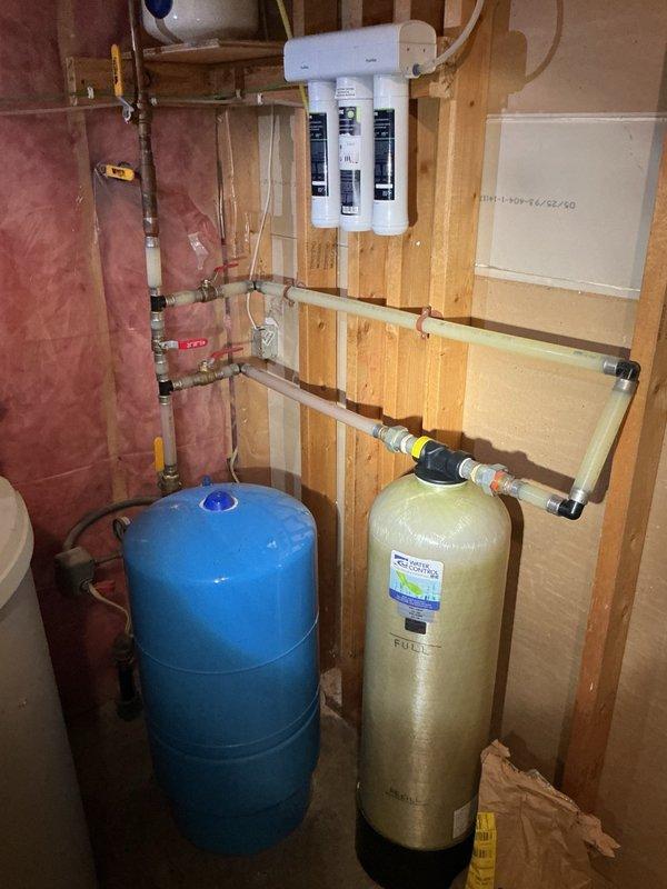 Responded to service call for installation of Moen Flo Smart Water Monitor and automatic shutoff valve on main water line. Upon inspection, discovered existing main line was galvanized pipe, which is incompatible with the customer-supplied automatic shutoff valve. Replaced galvanized main line section with appropriate piping to accommodate the smart shutoff device. During work, identified severely corroded pressure tank with rust deterioration on bottom. Presented replacement option, which was approved. Removed old pressure tank and installed new pressure tank with tank tee assembly. Integrated customer-provided automatic shutoff valve into the updated main line configuration. Restored water supply and performed comprehensive leak inspection at all connection points. Cycled well pump system multiple times to verify proper operation of new pressure tank, confirm shutoff valve functionality, and ensure system pressure regulation was operating within normal parameters. All components test