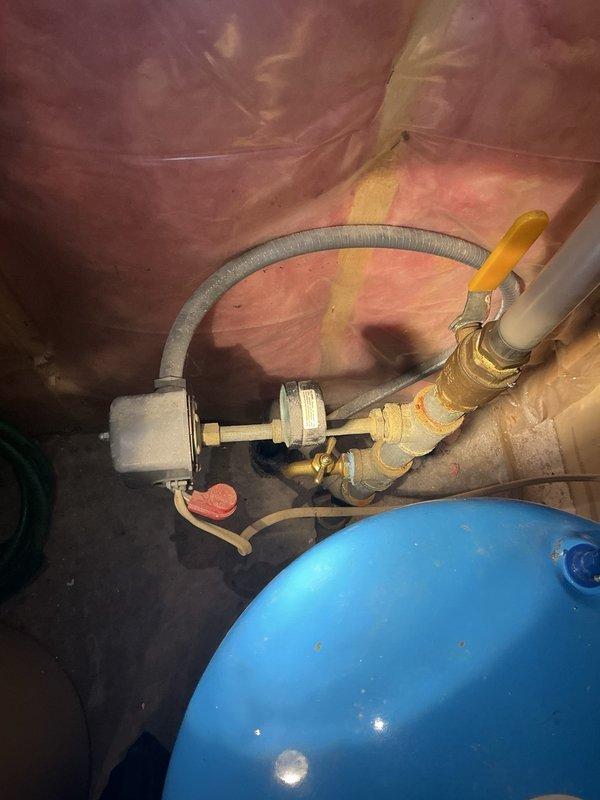 Responded to service call for installation of Moen Flo Smart Water Monitor and automatic shutoff valve on main water line. Upon inspection, discovered existing main line was galvanized pipe, which is incompatible with the customer-supplied automatic shutoff valve. Replaced galvanized main line section with appropriate piping to accommodate the smart shutoff device. During work, identified severely corroded pressure tank with rust deterioration on bottom. Presented replacement option, which was approved. Removed old pressure tank and installed new pressure tank with tank tee assembly. Integrated customer-provided automatic shutoff valve into the updated main line configuration. Restored water supply and performed comprehensive leak inspection at all connection points. Cycled well pump system multiple times to verify proper operation of new pressure tank, confirm shutoff valve functionality, and ensure system pressure regulation was operating within normal parameters. All components test