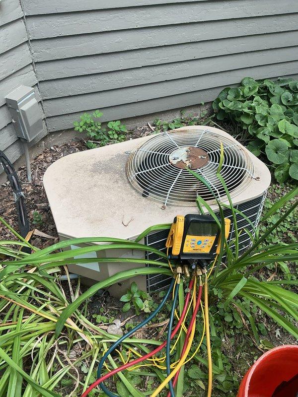 Responded to no cooling complaint with indoor temperature unable to drop below 83 degrees. Upon inspection, diagnosed system as critically low on R22 refrigerant, resulting in frozen evaporator coil that blocked airflow to living space. Performed diagnostic testing on outdoor condenser unit and confirmed refrigerant loss in aging system using obsolete R22. Due to system age and refrigerant phase-out, recommended complete system replacement and scheduled replacement estimate.