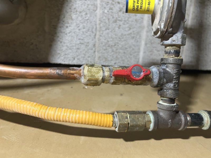 Returned to property to install gas shut-off valve in basement as previously sold. Installed new gas shut-off valve with red handle on main gas line, creating flared connection on top fitting to ensure proper seal. Upon completion, performed comprehensive leak testing on all connections using approved methods to verify system integrity. Successfully re-lit pilot lights for water heater and fireplace, confirming proper gas flow and safe operation of all appliances.