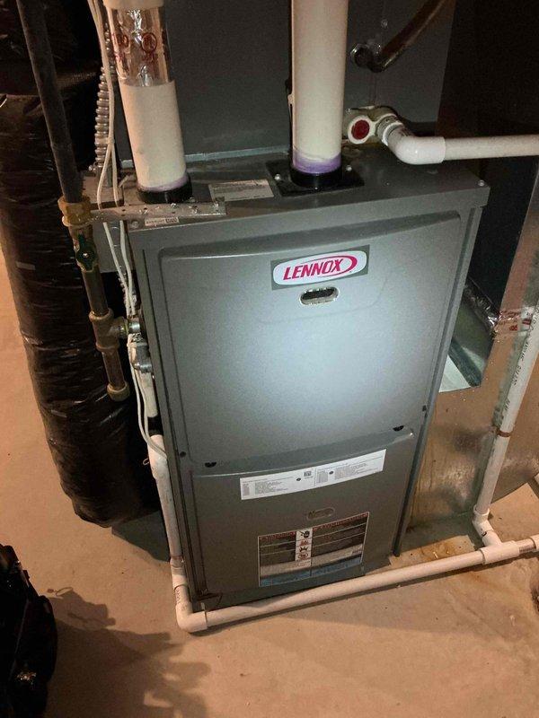 Responded to a no cooling complaint on an 8-year-old Lennox 13ACXN036 air conditioning system that was running continuously but unable to reach setpoint. Upon arrival, performed diagnostic testing and discovered the system had essentially no refrigerant charge, confirmed through measurements with the system both running and off. Investigated a previous diagnosis of a restricted filter drier by taking temperature readings across the component, which showed no notable temperature drop; however, this may not be conclusive given the critically low refrigerant level. Additional inspection revealed a failed capacitor reading out of manufacturer specifications and a contactor showing signs of electrical burning and deterioration. Documented all findings with photos of the indoor unit and internal components. Reviewed all repair options with the homeowner and coordinated scheduling of a service advisor for same-day follow-up to provide comprehensive repair estimates.