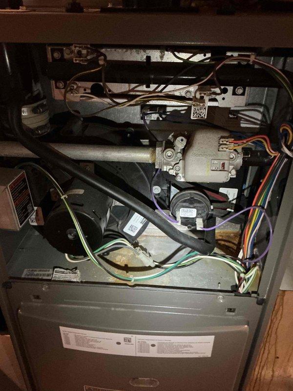 Responded to a no cooling complaint on an 8-year-old Lennox 13ACXN036 air conditioning system that was running continuously but unable to reach setpoint. Upon arrival, performed diagnostic testing and discovered the system had essentially no refrigerant charge, confirmed through measurements with the system both running and off. Investigated a previous diagnosis of a restricted filter drier by taking temperature readings across the component, which showed no notable temperature drop; however, this may not be conclusive given the critically low refrigerant level. Additional inspection revealed a failed capacitor reading out of manufacturer specifications and a contactor showing signs of electrical burning and deterioration. Documented all findings with photos of the indoor unit and internal components. Reviewed all repair options with the homeowner and coordinated scheduling of a service advisor for same-day follow-up to provide comprehensive repair estimates.