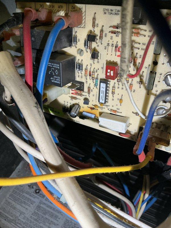 Performed comprehensive AC maintenance and system evaluation on aging 35-40 year old unit. Inspected all AC components and furnace elements, identifying failing control board and exhaust fan requiring attention. Documented system condition with photos of control board showing wire connections and component layout, and recommended replacement of draft motor and contactor to ensure continued reliable operation.