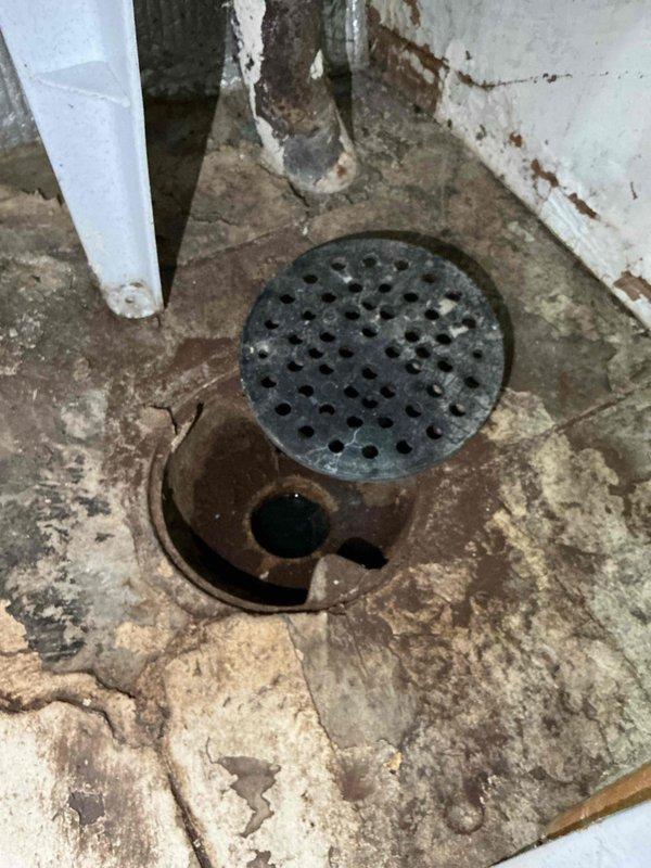 Responded to a floor drain backup occurring when the washing machine was in use. Upon inspection, diagnosed debris buildup in the drain line restricting proper flow and causing the floor drain to overfill. Utilized a flex shaft machine to clear the obstruction from the drain line, running water simultaneously to flush debris and restore proper drainage. Tested the system by filling and dumping the laundry tub multiple times to verify the floor drain no longer overflowed, confirming all components were functioning correctly upon completion.