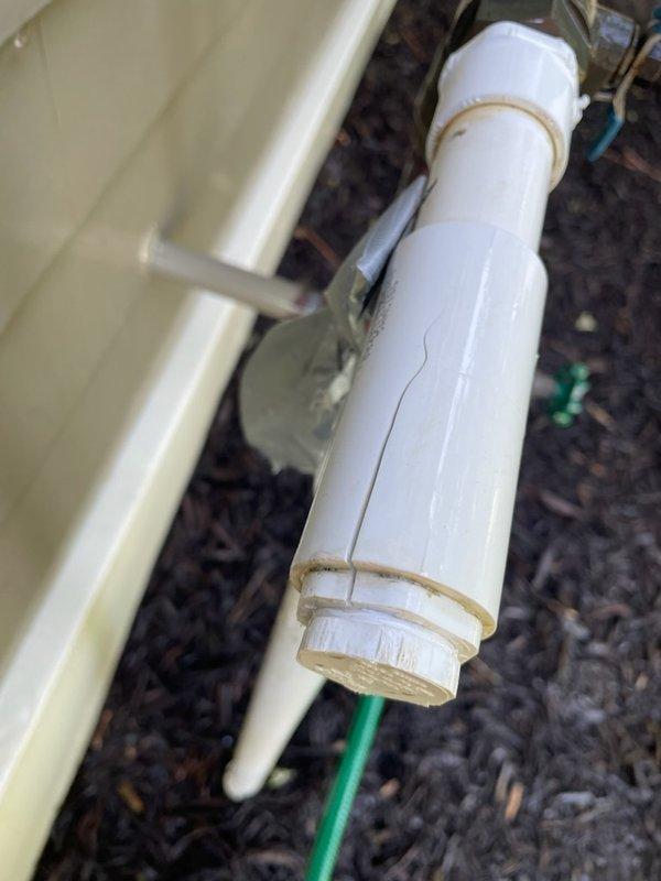 Responded to a call for a cracked PVC fitting on an exposed irrigation line. Upon arrival, identified a damaged white PVC pipe fitting with a vertical crack and discoloration from age and mineral deposits. Removed the failed fitting and installed a new PVC connector to restore system integrity. After installation, activated the irrigation system and conducted a 10-minute pressure test to verify proper operation and confirm no leaks were present. System was left in full service with all components functioning correctly.
