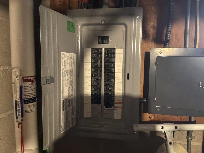 Responded to service call for bedroom above unheated garage experiencing inadequate heating in winter and excessive heat in summer. Assessed room conditions and determined insufficient insulation and lack of proper climate control as primary issues. Documented existing electrical panel configuration and available circuit capacity for potential supplemental baseboard heating system installation. Provided estimate for adding supplemental baseboard heat/cooling system to address temperature control deficiencies in the affected space.