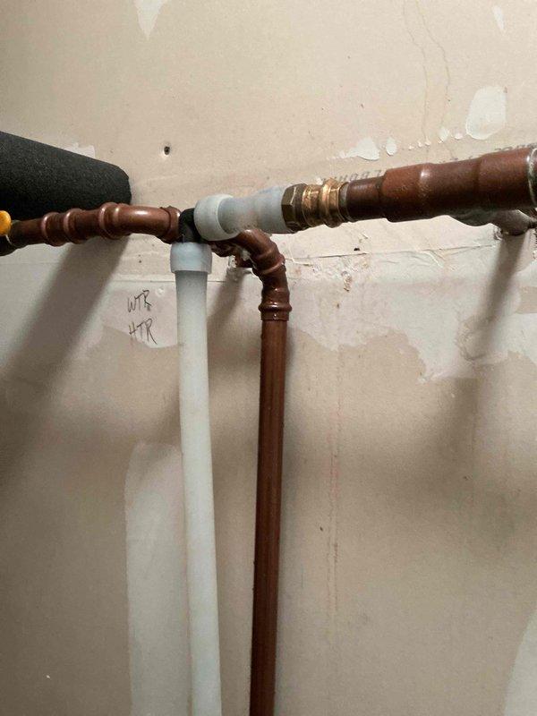 Responded to significant water leak in plumbing system connected to water softener. Upon inspection, identified failed Press 90 fitting as source of leak. Replaced compromised piping section from main water shut-off valve to water softener inlet using copper pipe and appropriate fittings. Installed new ball valves with red handles for improved shut-off control. Tested system for proper water flow and verified no additional leaks present. System restored to full operation with secure connections throughout repaired section.
