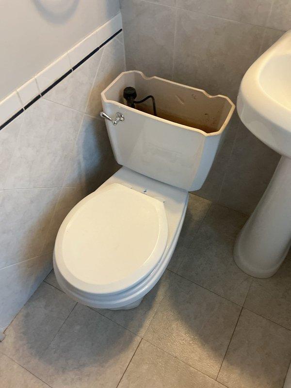 Responded to service call for toilet backing up and overflowing in upstairs bathroom of 1925 craftsman home, causing water damage to basement below. Inspected existing toilet installation and identified failed toilet bend requiring replacement. Assessed plumbing system and determined need for 14" rough-in toilet replacement. Provided comprehensive estimate covering new toilet installation, toilet bend repair, complete drain line repipe, and water supply line repipe to address underlying plumbing issues in older home. Documented existing bathroom conditions and basement mechanical area. Scheduled follow-up installation work.