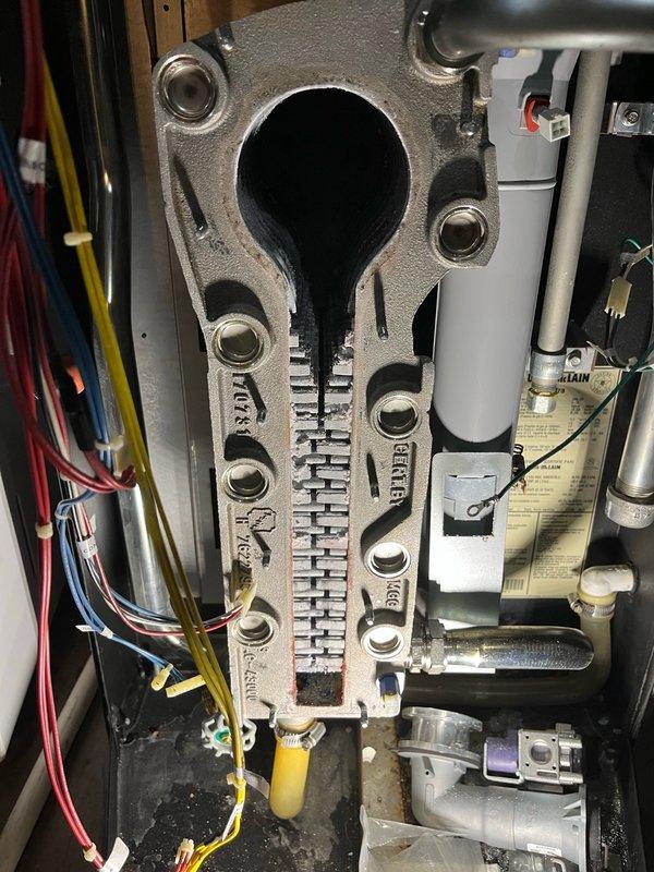 Performed comprehensive boiler tune-up on Weil-McLain system. Cleaned heat exchanger and drain trap, replaced gaskets, igniter, and flame sensor. All components were thoroughly cleaned, reinstalled, and leak checked. Verified proper operation for both domestic hot water and in-floor heating systems, reset maintenance reminder on boiler control panel, and confirmed system is functioning correctly.