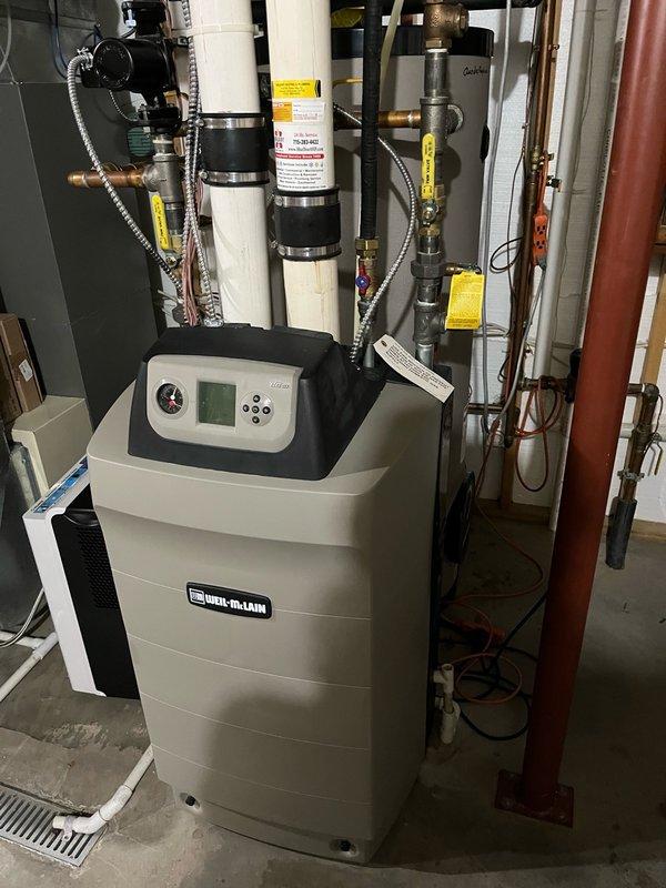 Performed comprehensive boiler tune-up on Weil-McLain system. Cleaned heat exchanger and drain trap, replaced gaskets, igniter, and flame sensor. All components were thoroughly cleaned, reinstalled, and leak checked. Verified proper operation for both domestic hot water and in-floor heating systems, reset maintenance reminder on boiler control panel, and confirmed system is functioning correctly.
