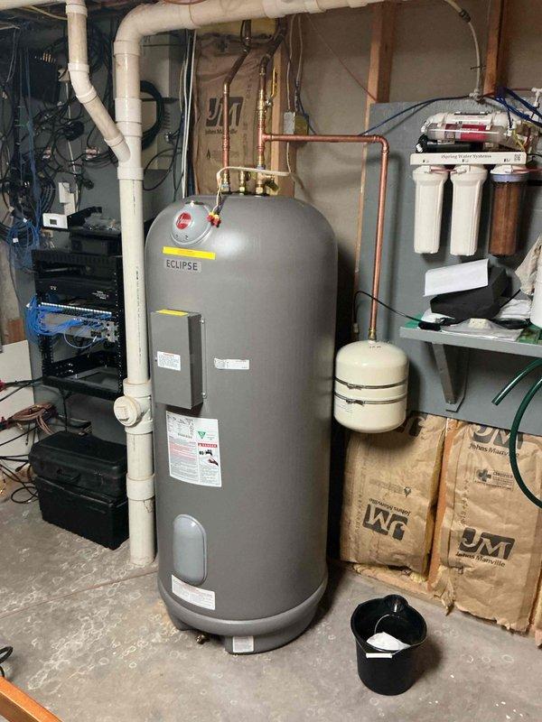 Completed installation of customer-supplied Marathon Eclipse electric water heater in basement utility area. Installed new water heater with proper copper piping connections, expansion tank mounting, and integration with existing plumbing system. All connections were secured, system was tested for proper operation, and installation was completed to meet same-day service request.