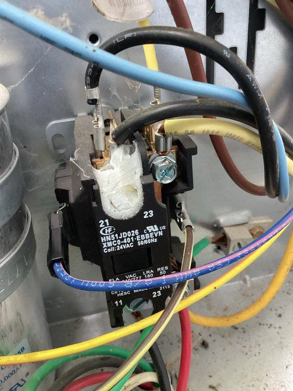 Responded to no cooling complaint on Carrier air conditioning unit. Found contactor severely burned out with visible heat damage and white residue accumulation on the component body. Replaced failed contactor with new unit per PO# 241292-001. During troubleshooting, discovered compromised wiring that appeared damaged beyond the immediate connection point. Attempted to isolate and remove affected wire section, but determined the entire wire run may require replacement for safe, reliable operation. System restored to operational status with new contactor installed, though wiring concern was noted for future service consideration. Total service time approximately 2 hours.