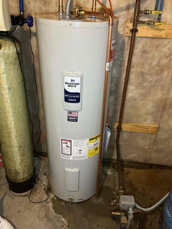 Responded to emergency call for electric water heater with smoke and fire damage. Upon arrival, confirmed water heater had caught fire with visible burn marks and damage to unit. Safely disconnected electrical supply at breaker panel and shut off water supply. Removed damaged 50-gallon electric water heater and installed new Bradford White 50-gallon electric water heater. Connected all copper supply lines, installed new shut-off valves, and ran flexible electrical conduit to breaker panel. Verified proper electrical connections, restored power, filled tank, and tested unit for proper operation and safety. All connections checked for leaks and system confirmed operational.