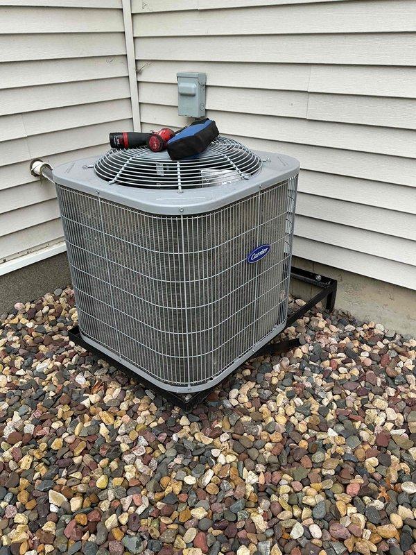 Completed annual AC maintenance tune-up on Carrier condensing unit. Replaced air filter that had not been serviced in over six months. Verified evaporator drain line was flowing properly and confirmed blower fan speeds were operating within specifications. Inspected outdoor unit electrical components and tested capacitor, which measured 32 microfarads against rated capacity of 40 microfarads, indicating weakened performance. Cleaned condenser coil by rinsing debris and buildup from fins. Advised homeowner of capacitor condition and recommended replacement to prevent potential compressor failure; homeowner elected to discuss with spouse before authorizing repair.