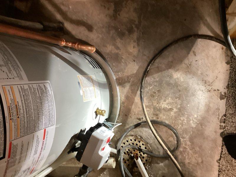 Responded to service call for gas water heater experiencing active leaks from both top and bottom of unit. Upon inspection, confirmed significant water discharge from multiple points on the tank, indicating catastrophic failure of the vessel integrity. Unit was determined to be covered under manufacturer warranty. Proceeded with complete water heater replacement, removing the failed unit and installing new gas-fired storage water heater. Connected all copper supply lines, gas piping, and temperature/pressure relief valve discharge piping to code specifications. Installed proper venting system and verified all connections for proper operation and absence of leaks. Tested new unit for functionality, confirmed proper ignition sequence, and verified adequate hot water delivery throughout the system.