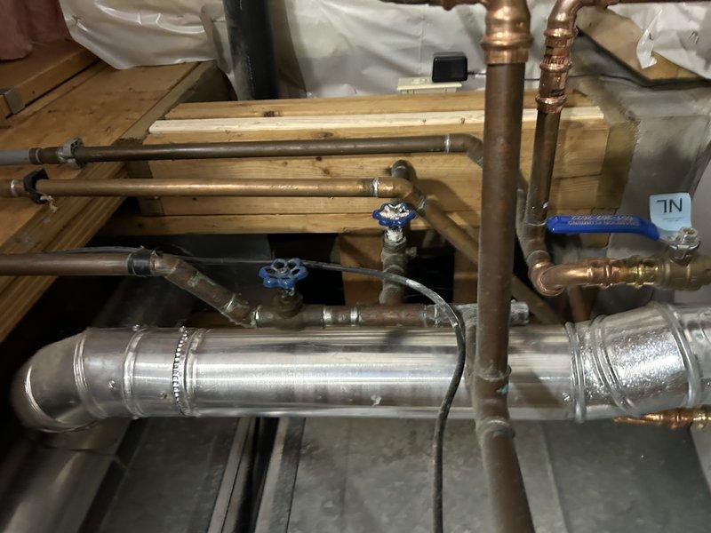 Replaced two exterior hose bibs that were leaking with new brass valve assemblies featuring green wheel handles, mounted on vinyl siding. Inspected basement plumbing connections including copper supply lines, ball valves, and manifold assembly to verify proper operation and ensure no additional leaks were present in the system.