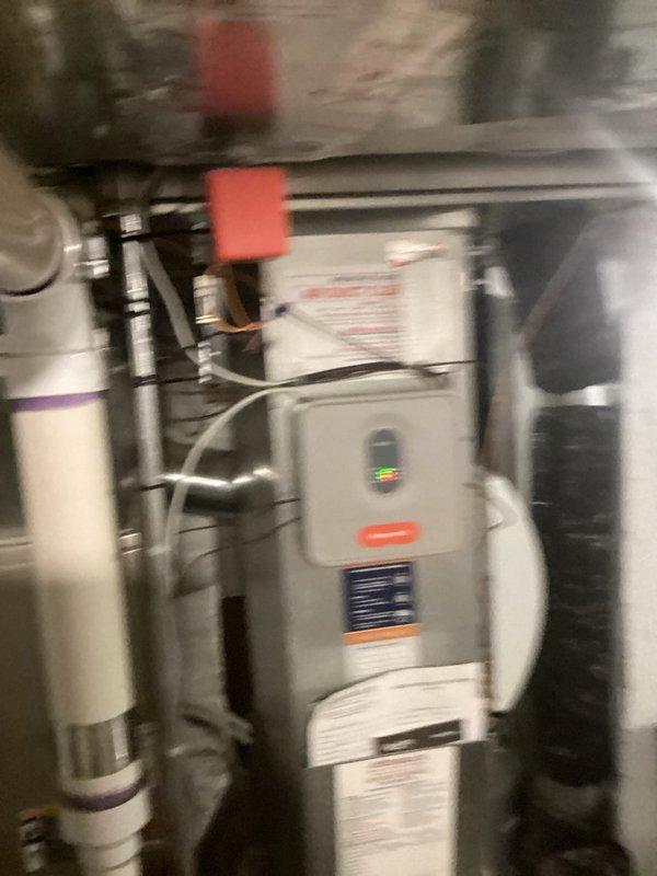 Responded to callback for zone system damper malfunction. Upon inspection, discovered the 2nd/3rd floor zone wiring was incorrectly connected to zone 3 position instead of zone 2 position on the zone panel and relocated wiring to proper terminal. Found stopping bars on both zone damper motors for 2nd/3rd floor zones were improperly positioned, preventing full range of motion. Adjusted stopping bars on both motors to allow complete opening and closing operation. Cycled system through all zone combinations and verified all three zone dampers now operate as designed. Noted one zone motor required manual assistance to close on initial test but functioned properly on subsequent cycles, indicating potential early-stage motor failure. Measured voltage drop from 40VA transformer showing 26.5V at source but only 24.5V at zone panel, which currently powers zone panel, three zone motors, and two thermostats—voltage may become insufficient for reliable operation if it drops below 24V.