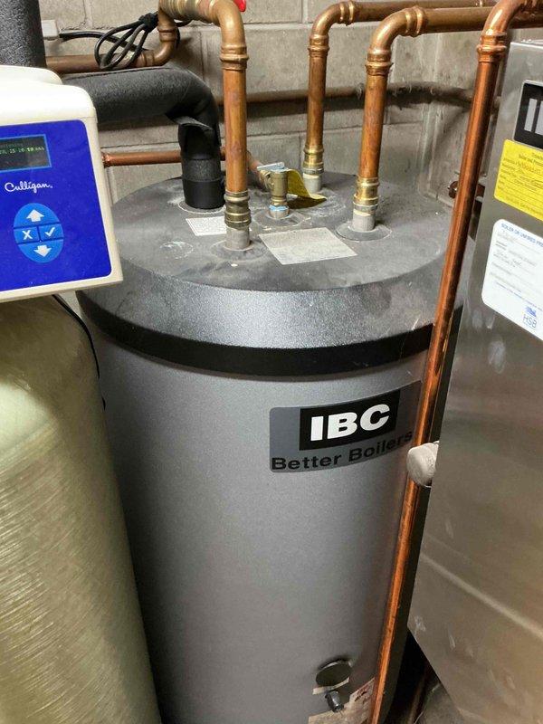 Replaced defective ASME pressure relief valve on IBC boiler system that was actively leaking. Drained system water, disassembled necessary components to access the failed relief valve, cut out the old valve, and installed new pressure relief valve using proper fittings. Re-pressurized the system, verified all connections were secure and leak-free, and confirmed proper operation of the boiler unit.