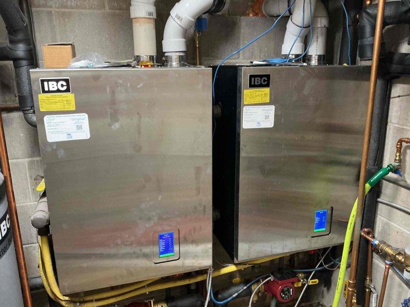 Replaced defective ASME pressure relief valve on IBC boiler system that was actively leaking. Drained system water, disassembled necessary components to access the failed relief valve, cut out the old valve, and installed new pressure relief valve using proper fittings. Re-pressurized the system, verified all connections were secure and leak-free, and confirmed proper operation of the boiler unit.