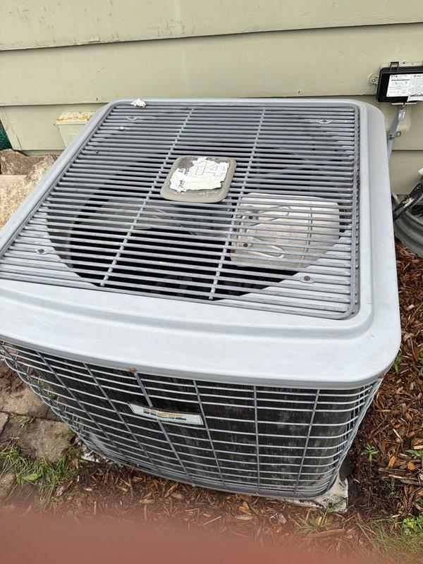 Responded to no cooling call on 2014 residential split system air conditioner. Found compressor operating but condenser fan motor not running. Upon inspection, discovered rodent damage to fan motor wiring. Repaired chewed wire connections and restored proper operation. Due to unit age (10+ years) and overall condition showing weathering and corrosion, provided equipment replacement quote for customer consideration.