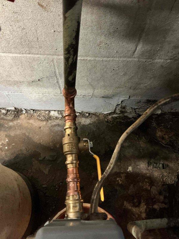 Responded to water supply leak at residential property serviced by private well system. Upon arrival, identified active leak at threaded gate valve on main water supply line. The existing brass gate valve showed deterioration at the threaded connections, causing water seepage that required immediate attention. Shut off water supply to the home to prevent further water damage and allow for safe repairs. Removed the failed threaded gate valve from the copper piping assembly. Installed new shutoff valve with proper threading and sealing to restore water supply integrity. Tested the new installation under full pressure to verify leak elimination and proper valve operation. Restored water service to the residence with all connections secure and functioning correctly.