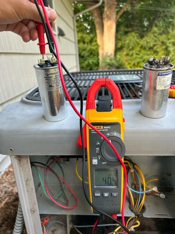 Responded to no cooling complaint on 25+ year old Weathermaker unit producing deep vibrating sound. Found failed dual run capacitor with compressor terminal reading open and fan terminal at 5.0 µF; condenser humming confirmed capacitor failure. Replaced dual run capacitor and extremely dirty air filter. Post-repair system testing revealed refrigerant circuit operating improperly. Customer informed of refrigerant issue and system malfunction but declined further repairs and equipment replacement at this time.