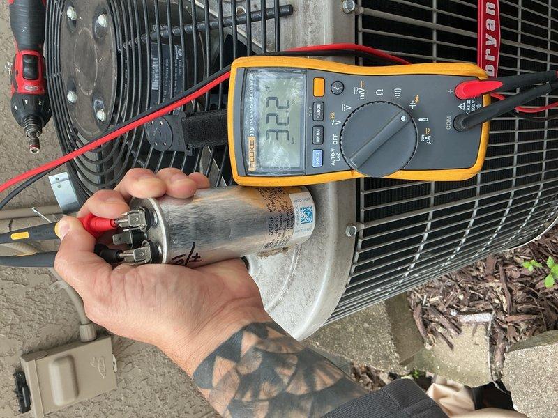 Responded to no cooling call on 11-year-old residential AC system. Upon arrival, homeowner reported outdoor condenser fan running intermittently and stopping. Diagnosed failed dual-run capacitor reading 32/0 MFD out of rated 35/5 MFD. Replaced defective capacitor with proper OEM replacement, restoring normal condenser fan operation. Performed complete system verification including contactor inspection, refrigerant charge analysis, air filter condition check, and temperature split measurements across evaporator coil. All parameters confirmed within manufacturer specifications. System returned to full cooling operation with no further issues detected.