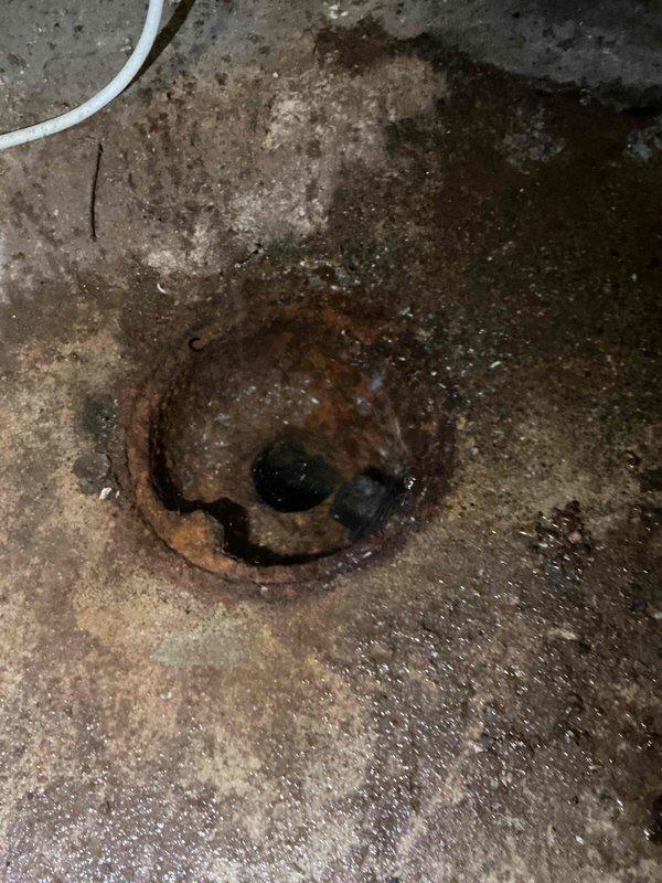 Responded to a laundry drain backup complaint where the floor drain was backing up during washing machine use. Upon arrival, verified the issue and performed diagnostic testing by flushing the toilet, which confirmed the blockage was isolated to a branch line rather than the main sewer line. 

Cleared the obstruction using a flex shaft drain machine to mechanically open the floor drain line. Following the clearing procedure, conducted thorough flow testing by running water through the system and introducing 10 gallons of water down the drain to verify proper drainage and flow capacity. The line demonstrated full functionality with no backup or slow drainage observed. No debris or materials were retrieved during the cleaning process, indicating the blockage was successfully pushed through the line. The floor drain is now operating normally with proper flow restored.