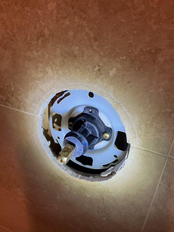 Responded to service call for shower temperature issue and toilet replacement evaluation. Upon inspection, found incorrect trim and cartridge installation on shower valve causing lack of hot water. Adjusted temperature limiting mechanism on existing valve to restore proper hot water function. Assessed gravity-fed toilet with pull chain mechanism for replacement and provided estimate for new toilet installation. Evaluated exterior spigot requiring repair and provided bid for replacement. Documented existing conditions including vintage hexagonal tile flooring and current fixture configurations for future reference.