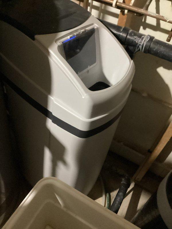 Responded to service call for water softener not flushing properly with excessive water in brine tank. Upon inspection, determined system was low on salt, which prevented normal regeneration cycle. Added salt to brine tank and manually initiated brine draw cycle for 20 minutes to reduce water level and restore proper system operation.
