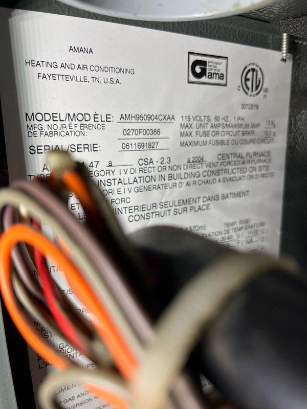 Performed comprehensive AC tune-up on 20+ year old Amana system with reported storm damage to condenser coil and excessive runtime concerns. Inspected outdoor unit and found condenser coil fins damaged but insufficient area affected to impact system function; determined fin straightening would cause more harm than good given age and condition of coil. Tested system operation with manifold gauges and identified low R-22 refrigerant charge and severely pitted contactor. Monitored system for 15 minutes during operation, confirming 10-15 degree temperature drop across evaporator. All components functioned properly despite age-related wear. Advised that refrigerant recharge and repairs not recommended due to system age and overall condition; recommended replacement system pricing for consideration.