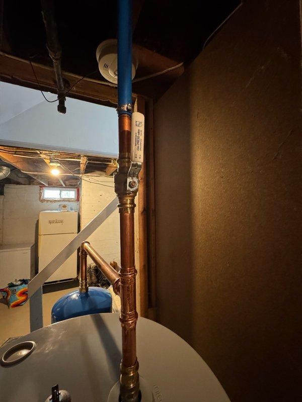 Completed installation of a standard 50-gallon electric water heater in basement utility room, replacing existing unit of similar specifications. Drained and removed old water heater, then positioned new unit against brick wall with proper clearances. Installed expansion tank to protect home's water lines, fixtures, and extend tank life. Ran new dedicated electrical circuit for water heater, including opening and closing ceiling access as needed. Connected copper supply lines with brass fittings and completed all plumbing connections per code requirements. Verified proper operation of all components including pressure relief valve, expansion tank function, and electrical connections. New unit includes 10-year parts and tank warranty with 1-year labor warranty.