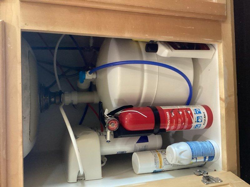 Performed scheduled maintenance on residential water treatment system including replacement of reverse osmosis membrane filter under kitchen sink and 20-inch iron reduction cartridge filter in basement filtration unit. Verified proper system operation and pressure readings on all equipment following filter replacement.