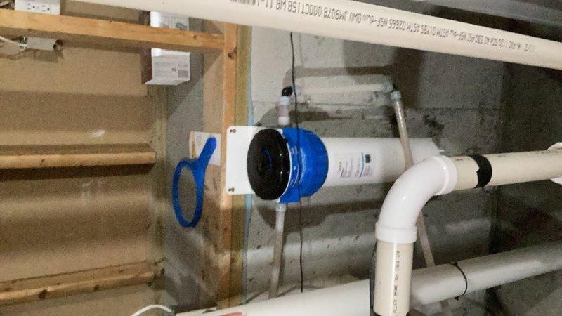 Performed scheduled maintenance on residential water treatment system including replacement of reverse osmosis membrane filter under kitchen sink and 20-inch iron reduction cartridge filter in basement filtration unit. Verified proper system operation and pressure readings on all equipment following filter replacement.