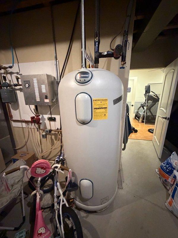 Responded to report of water accumulation in basement mechanical room. Upon inspection, identified condensation on multiple pipes and traced source to failed main ball valve showing active leak. Removed defective ball valve and damaged pipe section. Installed new ball valve with replacement piping to restore proper water supply control and eliminate leak condition.
