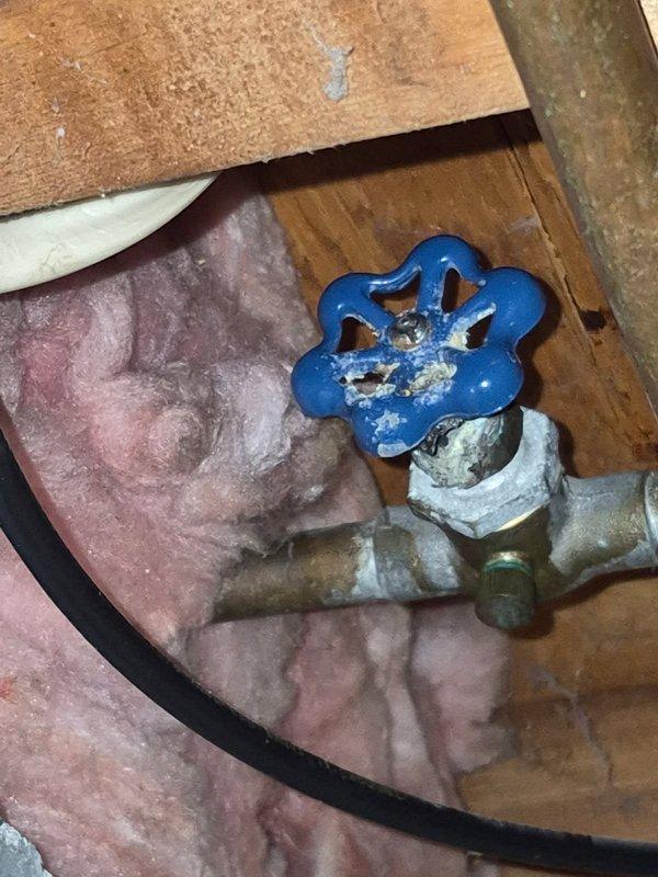 Responded to emergency service call for leaking shower faucet with no water shut-off valves present. Main water supply to home was shut off to safely address the issue. Inspected the hot water side cartridge which was identified as the source of the leak. Disassembled, examined, and reassembled the cartridge, which stopped the active leak during testing. Advised homeowner that a temporary repair was completed without guarantee of long-term reliability, and recommended full valve replacement as a permanent solution if leaking recurs.