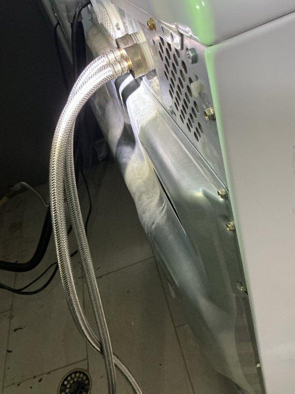 Responded to follow-up service call to investigate water leak affecting ceiling near washing machine location. Ceiling drywall had been previously removed to access plumbing infrastructure above subfloor level. Conducted thorough inspection of exposed joists, ductwork, and plumbing lines in ceiling cavity to locate source of leak. Ran washing machine through complete cycle while monitoring supply lines, drain connections, and surrounding plumbing components for active water discharge. Inspected flexible braided supply hoses, shut-off valves, and drain connections at washer location. Traced leak path from subfloor area through ceiling structure to determine origin point of water intrusion. Documented findings with photographic evidence showing exposed ceiling framework, mechanical systems, and affected areas for repair recommendations.