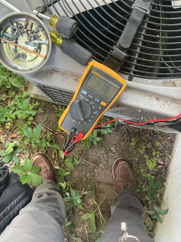 Responded to no cooling complaint on 19-year-old Carrier air conditioning system experiencing humming noise at outdoor unit. Diagnosed failed dual run capacitor on compressor circuit preventing compressor operation. Replaced dual capacitor, restoring system operation and cooling function. Verified contactor operation, confirmed refrigerant charge within specifications, and measured temperature split at 18 degrees across evaporator coil. Inspected condenser coil finding satisfactory cleanliness and confirmed air filter condition acceptable. During comprehensive system evaluation, identified cracked heat exchanger in furnace using borescope inspection camera. Performed safety shutdown and lockout of furnace due to heat exchanger failure presenting potential carbon monoxide hazard. Reviewed all available options with customer regarding both air conditioning repair and furnace replacement requirements. System now cooling properly with compressor working under elevated load due to high indo