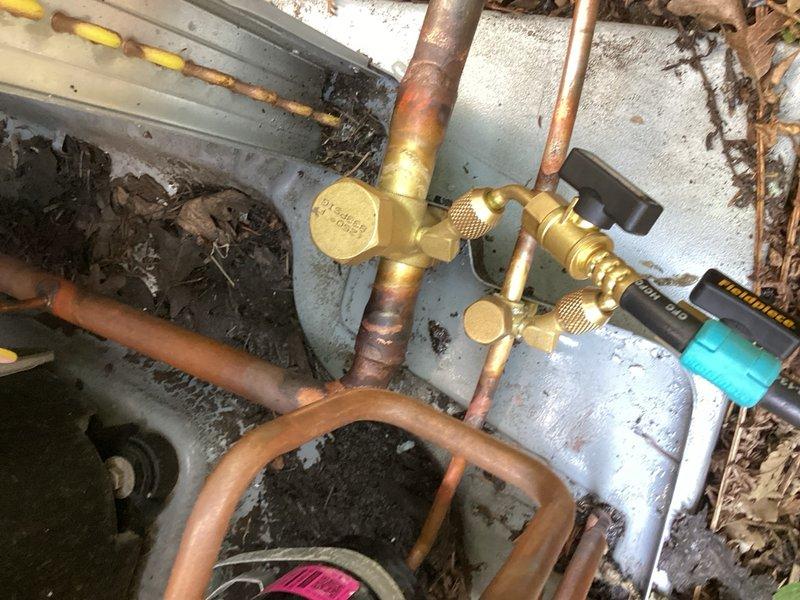 Responded to refrigerant leaks detected at the service valves on the outdoor condensing unit. Reclaimed all existing refrigerant from the system, removed the failed service valves, and brazed in new replacement valves. Performed comprehensive leak check to verify system integrity, then evacuated the system to proper vacuum specifications. Recharged the system with 7 lbs 12 oz of R-410A refrigerant per manufacturer specifications. Cycled the equipment through multiple operational modes and verified all parameters within normal operating range. Unit restored to full operational status with all repairs completed under warranty coverage.